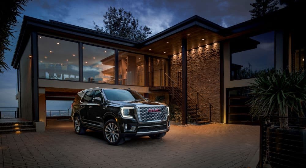 Black 2023 GMC Yukon Denali parked on a driveway after leaving a used GMC dealer
