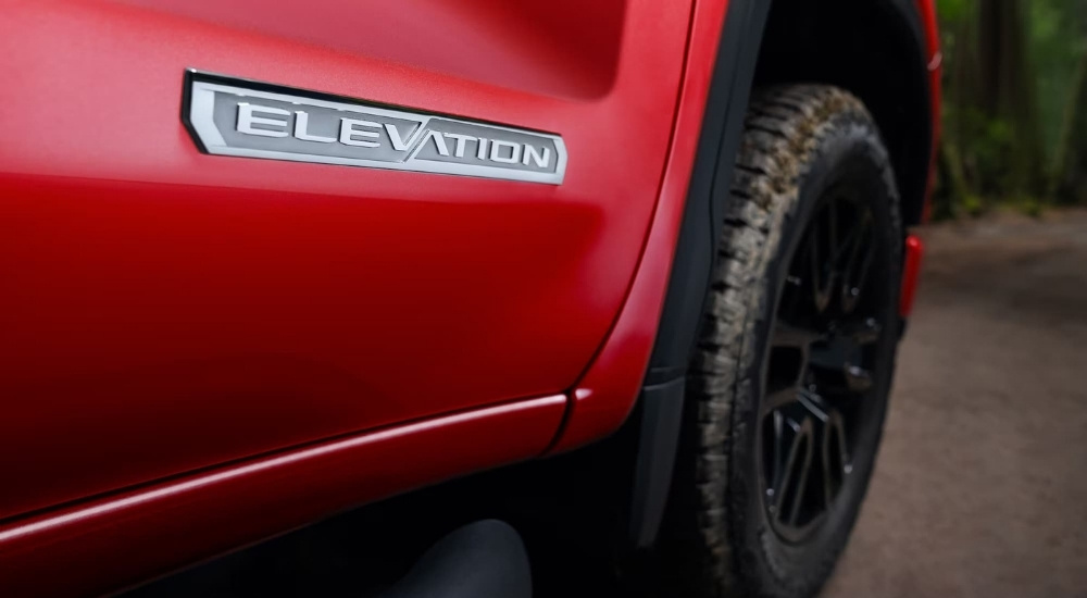 The 'Elevation" badge on a red 2025 GMC Sierra 1500 Elevation
