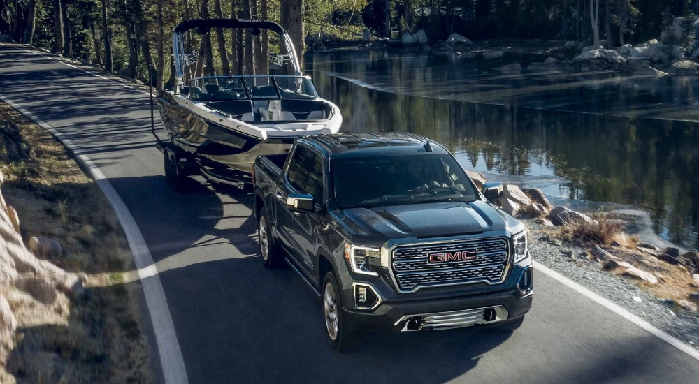 A black 2021 GMC Sierra 1500 towing a boat