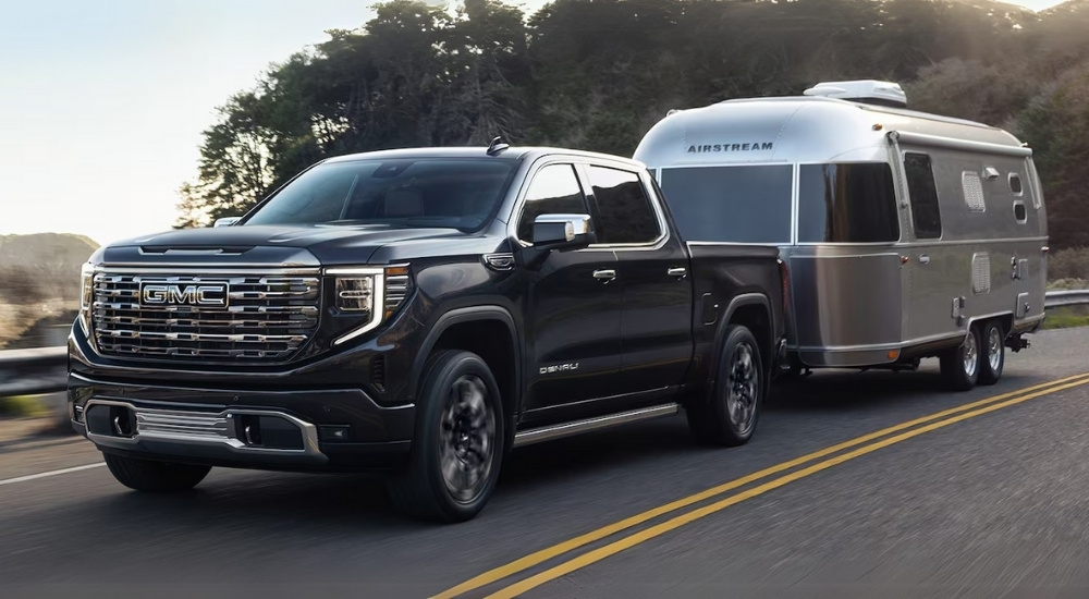 Black 2024 GMC Sierra 1500 Denali is towing an Airstream trailer