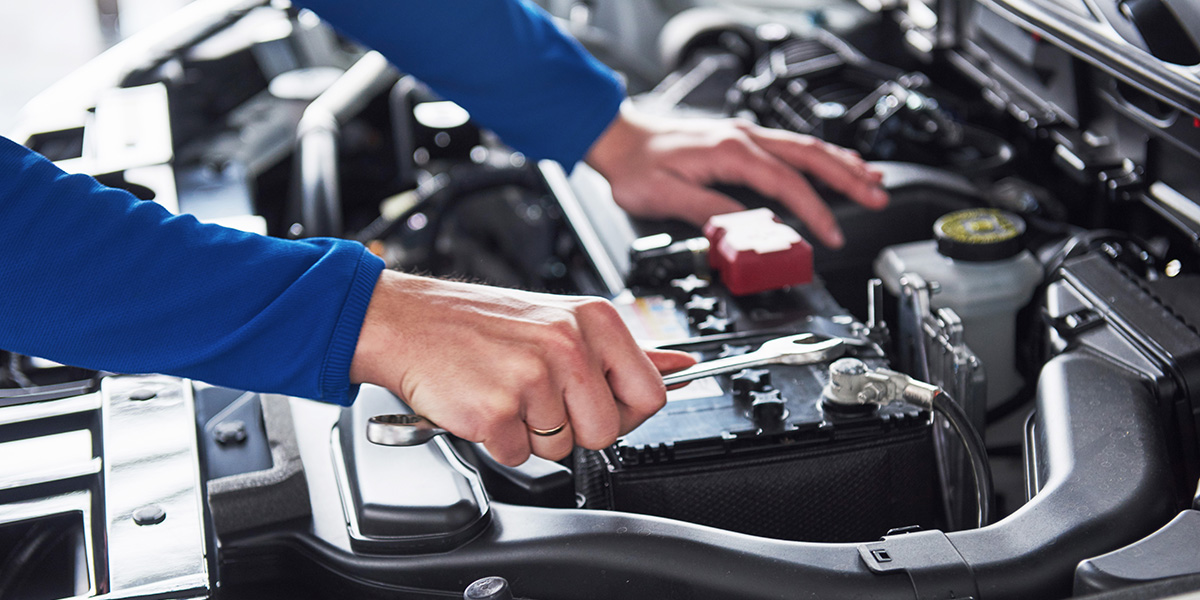 GMC Service Center Maintenance Professional servicing an SUV engine in Hopkinsville