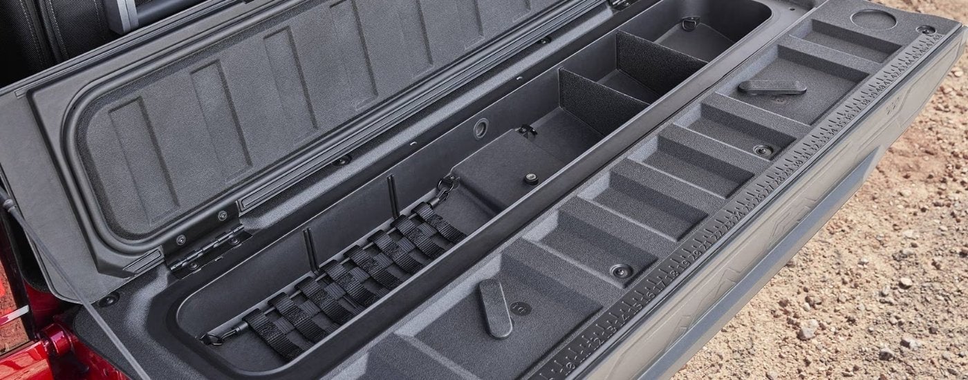 Open tailgate on a red 2025 GMC Canyon.
