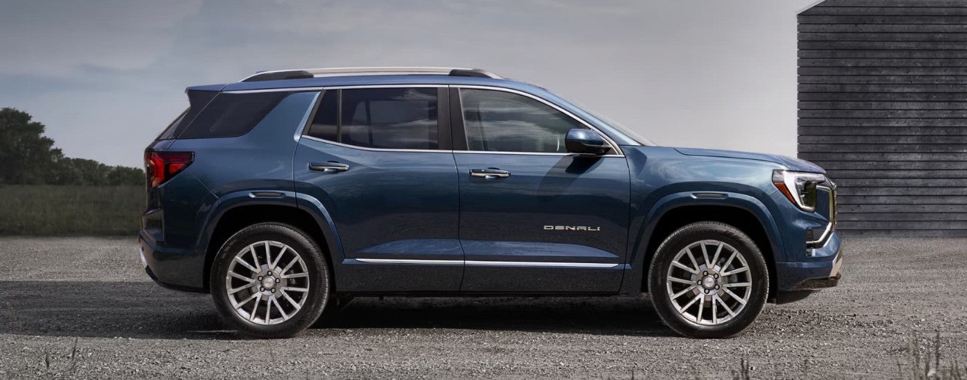 A blue 2026 GMC Terrain Denali side-view parked.