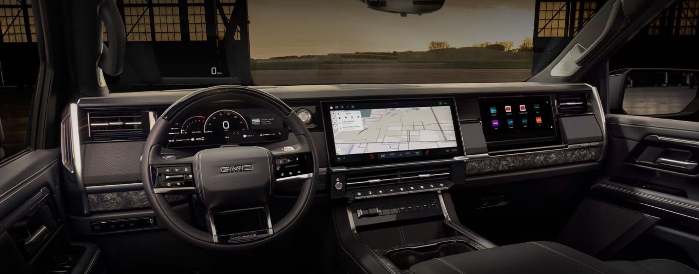 Infotainment display and steering wheel in a 2027 GMC Sierra 1500.
